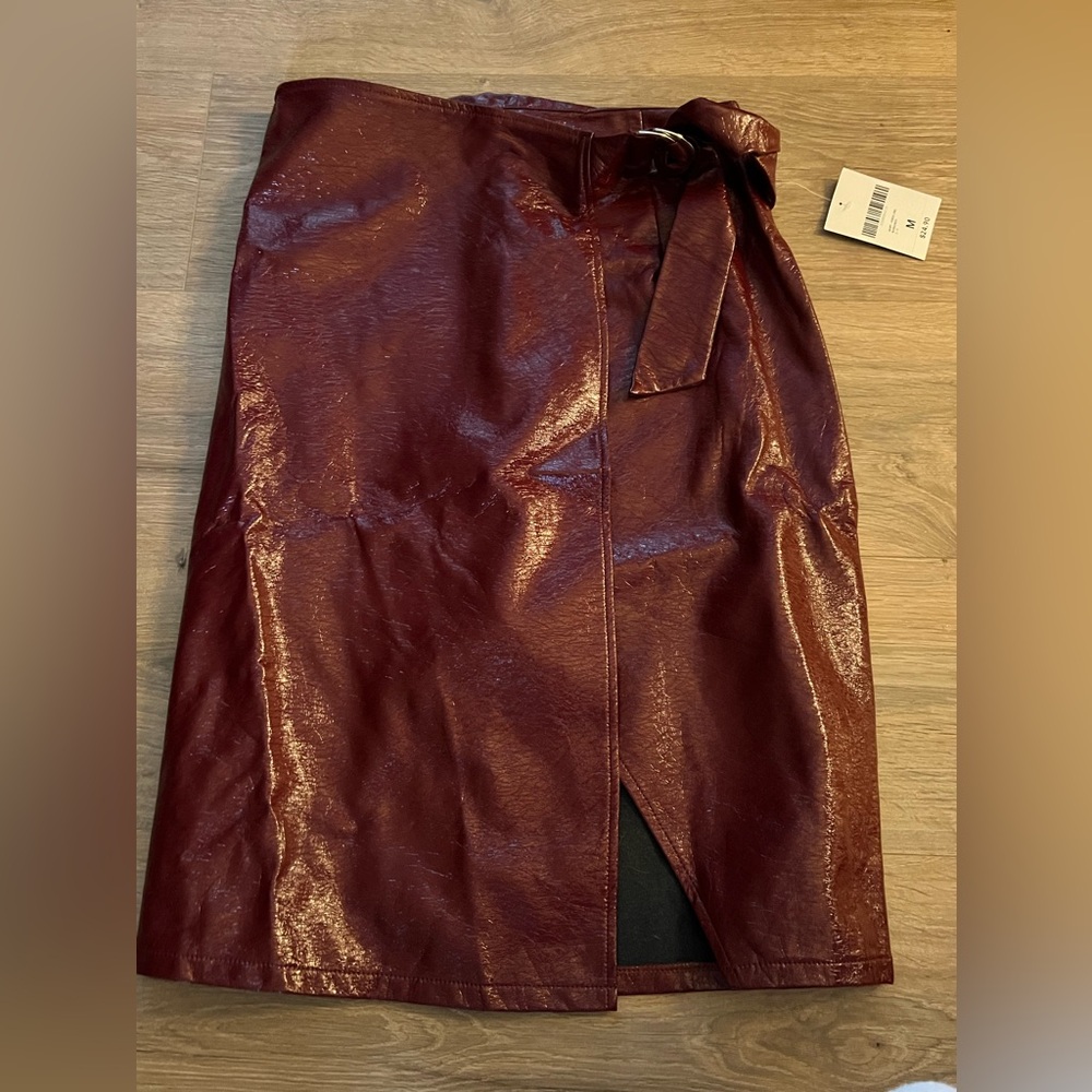Forever 21 knee length burgundy skirt. NWT. Size medium
